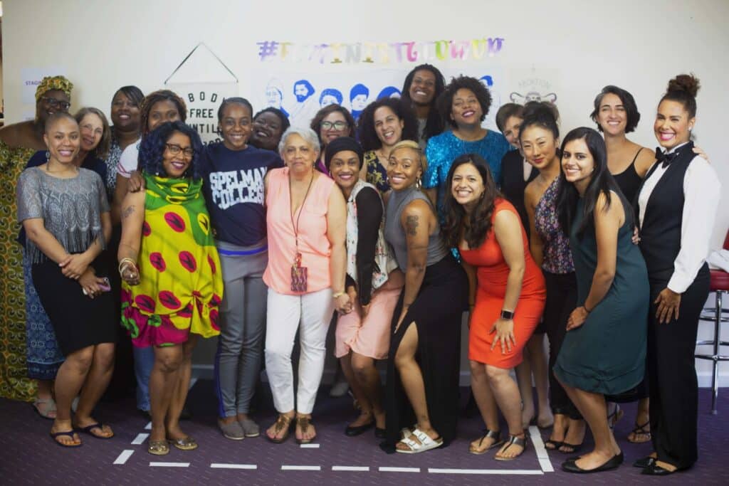 Feminist Center team smiles for a group picture.