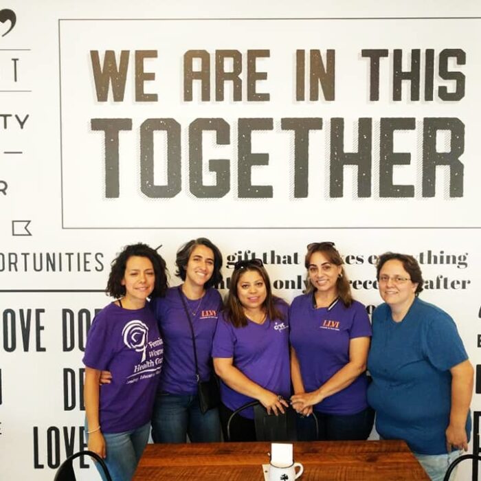 Group of members posing in front of a backdrop at a past LLVI Health Fair.