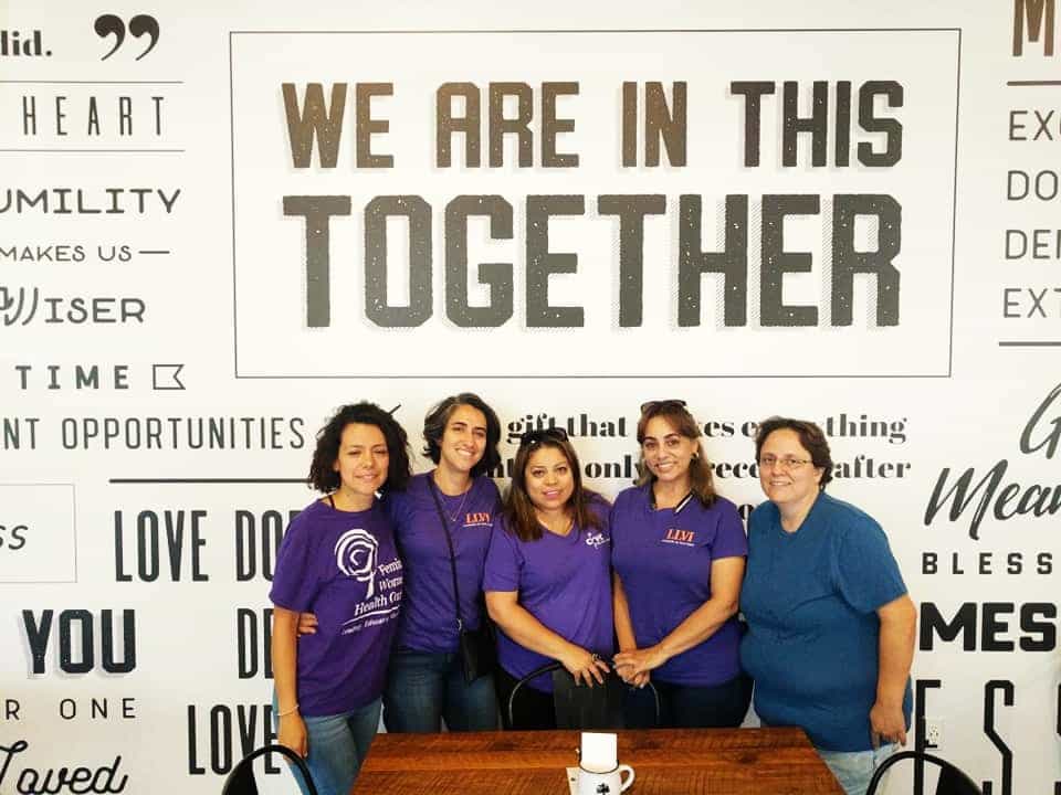 Group of members posing in front of a backdrop at a past LLVI Health Fair.