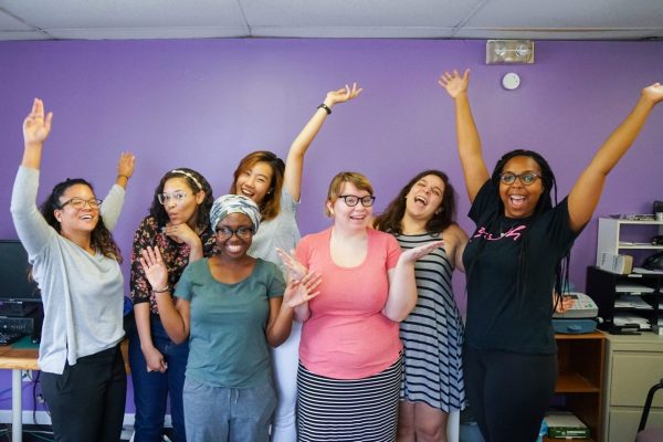 A group of interns poses for a light-hearted picture in the Feminist Women’s Health Center offices.