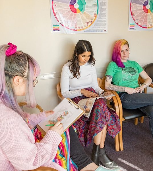 Three models pose as patients in the waiting room