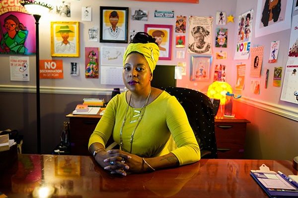 Feminist Women’s Health Center Executive Director, Kwajelyn Jackson, sits at the desk in her office.