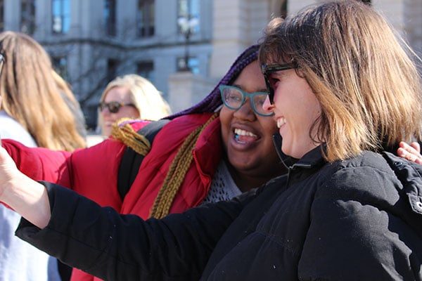 Two demonstrators pose for a selfie during a rally outside of the Georgia State Capitol.